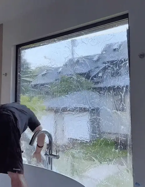 Animated demonstration of privacy film being applied to a window